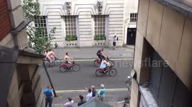 Naked cyclists pedal through London near Covent Garden