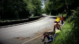 Medical staff tend to rider after crash throws him off bike at Isle of Man TT