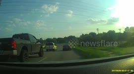 Crazy driver nearly hits oncoming traffic (caution strong language)