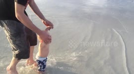 Baby running on beach