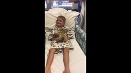 Clown doctors serenade boy before he receives heart surgery
