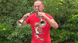 'Kung-fu master' carries buckets with his eye sockets while playing instrument through his nose