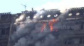 Grenfell Tower carcass with flame seen in a window