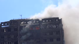 Grenfell Tower carcass in smoke as seen from Verity Close