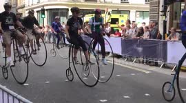 Old fashioned Penny Farthing bikes race through London