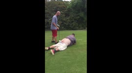 Man takes golf shot off friend's back side, causing a lot of pain
