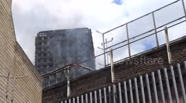 Grenfell Tower in smoke seen from Latimer Road