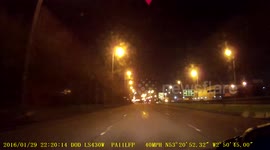 Car going wrong way around lights to avoid a red