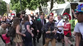 Police escorts a Tories out on the way for his safety during the Protest against THERESA MAY