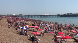 Thousands gather on Brighton beach on hottest day of the year