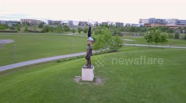 Climbing a statue a nice summer evening - filmed by drone