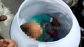 Dad transports son in plastic bucket on motorbike!