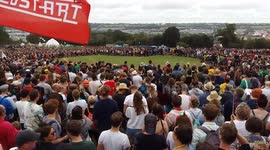 Thousands of festival-goers gather to form the world's largest peace sign