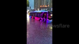Hero bus driver helps passengers off bus stuck on flooded street