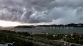 Time-lapse footage of dark clouds cover the sky