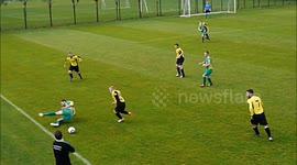 Amateur soccer player falls over after stepping on the ball