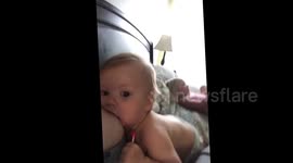 Breastfeeding baby talking with his mouth full.  Too cute!