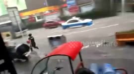 Delivery man chases after runaway package during windstorm