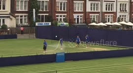 How many men does it take to water a tennis court at the Queen's Club?