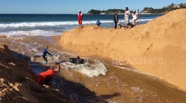 Local children enjoying lagoon release into ocean on a perfect winter day in Australia