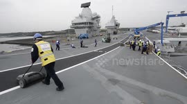 Tight spot! Britain's largest warship HMS Queen Elizabeth squeezes out of tight Rosyth dockyard