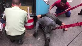 Passersby lift up bus to rescue man stuck under it
