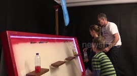 Father builds bottle flipping carnival game challenge for his children