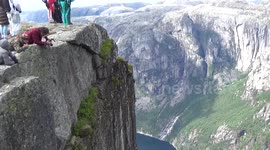 Base jumpers exiting 3000ft high cliff at Heliboogie BASE jumping event in Norway