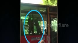 Driver climbs into bus to slap driver after argument