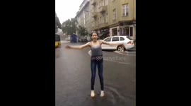 Teenager dances in the rain in flooded Berlin after severe weather