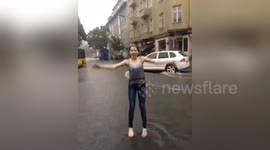 Newsflare Edit - Teenager dances in the rain in flooded Berlin after severe weather