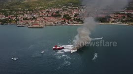 Firefighters battle a fire on sailboat in Split harbour, Croatia