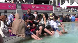 Summer Weather: Children cooling down at the Fountain in Trafalgar Square