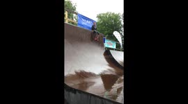Kid sliding down the ramps in rain