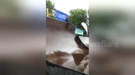 Newsflare Edit - Kid sliding down the ramps in rain
