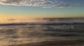 Steamy ocean beach sunise
