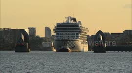 Viking Sky cruise ship passes through Thames Barrier at sunset