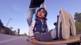 Father and 2-year-old son ride together on DIY longboard they made together