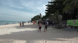 Tourists watch in horror as woman's body is found buried on Thailand beach