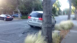 Older Lady driving on flat tire down Middlefield Road; Palo Alto, CA