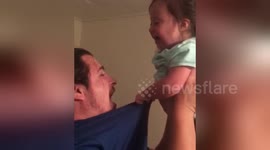 Daddy's heartwarming playtime with Down Syndrome baby as laughter and love fill the room