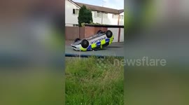 Police car tipped onto its roof