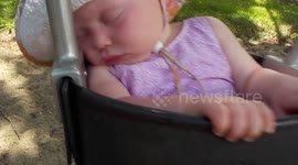 Baby struggles to stay awake on swing