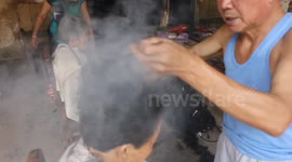 Chinese barber practises rare art of cutting hair with hot tongs