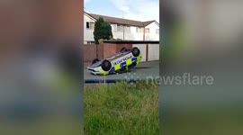 Police car turned onto its roof by 'gang' in Kirkby, UK