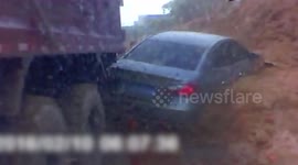 Eight vehicles trapped in massive landslide