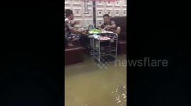 Restaurant customers continue meal despite flood