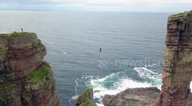 Alexander Schulz performs first slackline walk to sea stack in Scotland