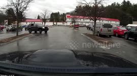 Older driver looking down at her cellphone enters an intersection oblivious to where she is driving.