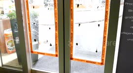 Shattered window in business door after looting and rioting during Hamburg G20